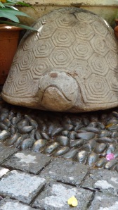 The stone turtle at the entrance to the restaurant